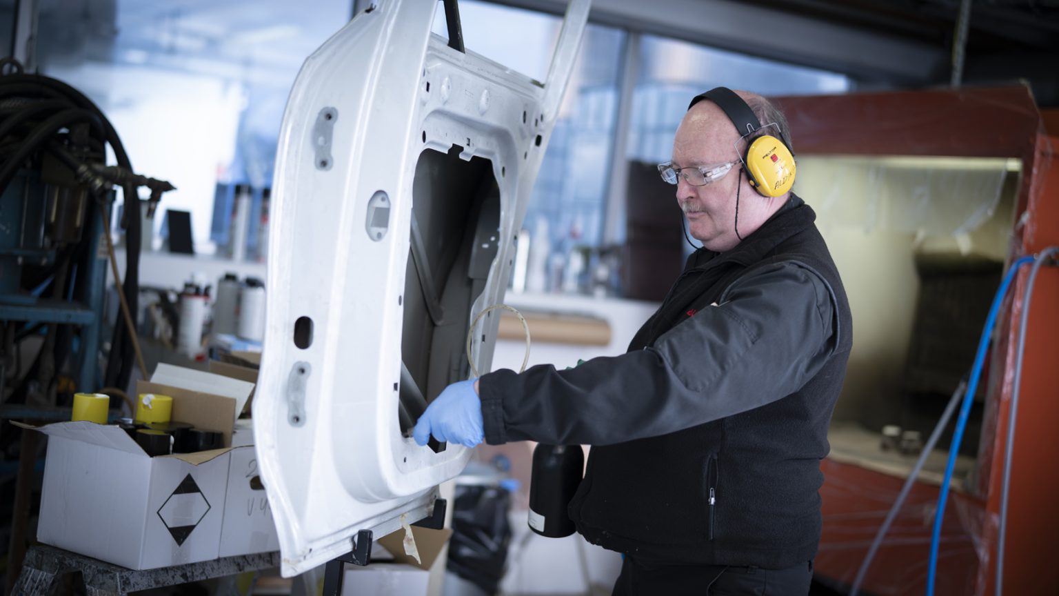 Professional corrosion treatment being applied inside a vehicle door