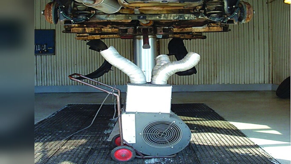 Hot-air drying equipment directing warm air beneath a raised vehicle